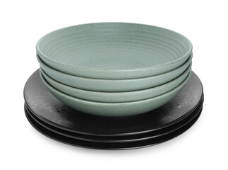 Stack of beautiful ceramic plates and bowls isolated on white