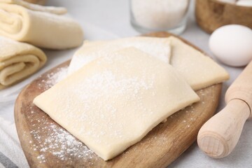 Fototapeta na wymiar Raw puff pastry dough on table, closeup