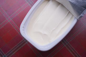 fresh butter in a container with bread on white background 