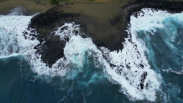 Coast and waves on volcanic rocks on a black sand beach at Reunion Island 003