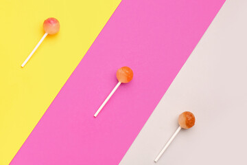 Sweet lollipops on colorful background