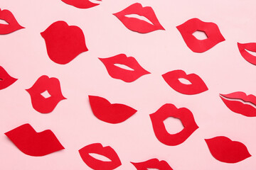 Red paper lips on pink background