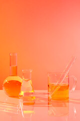 A podium in square shaped decorated with laboratory glassware against gradient background. Minimal podium display for cosmetic product presentation