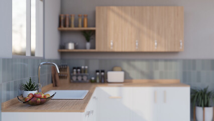 Side view of a sink on a minimalist wood kitchen counter in a modern bright and clean kitchen.