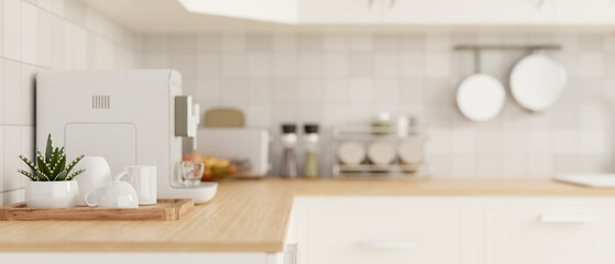 Side view of a kitchen countertop with kitchen appliances in a modern white kitchen.