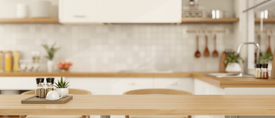 Copy space for displaying your product on a wooden dining table in a minimalist Scandinavian kitchen