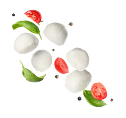Mozzarella balls, cut tomatoes, basil leaves and peppercorns falling on white background