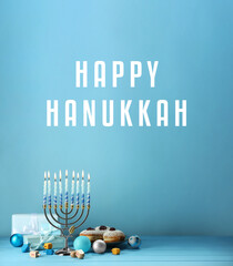 Happy Hanukkah. Menorah, donuts, gifts and dreidels on light blue background