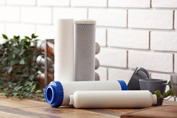 Water filters on wooden table in kitchen