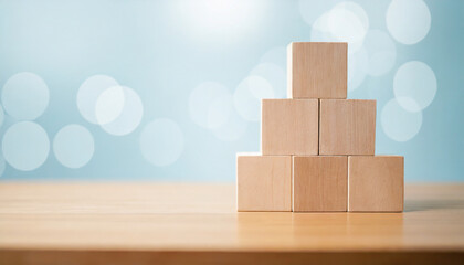 Neatly stacked wooden cubes on table with space for text/infographics symbolize organization, creativity, and customizable information display in a stock photo