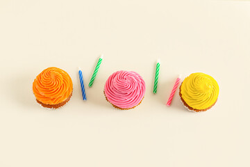 Tasty colorful cupcakes on white background