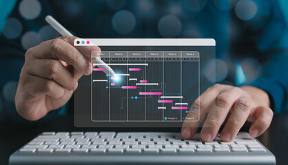 Exploring the project management concept, a site manager engages with Gantt chart schedules to plan and track engineering progress. Planning and corporate strategy for construction and operational.