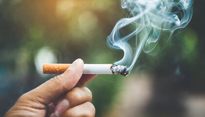 Close-up of hand crushing a burning cigarette, symbolizing determination to quit smoking