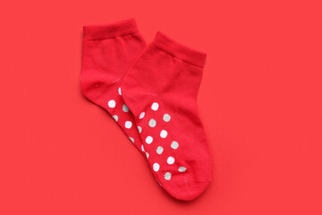 Pair of cotton socks on red background
