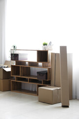 Shelving unit with cardboard boxes in office on moving day