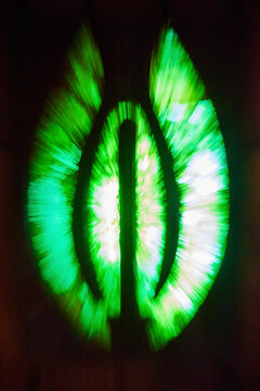 Abstract Green and Yellow Light Radials on Dark Background