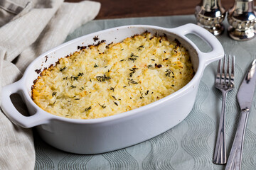 A casserole dish of homemade shepherd's pie topped with mashed cauliflower.