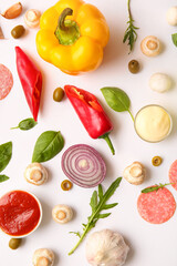 Naklejka premium Ingredients for preparing pizza on white background
