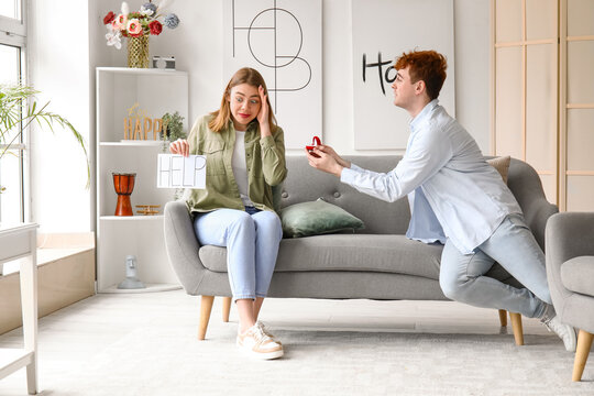 Young woman with word HELP get proposed at home