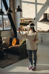 A young woman, immersed in an online game, wears a virtual reality headset at home.