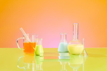 Pedestal for cosmetic product presentation with transparent podium, lab glassware filled colorful liquid on orange gradient background. Science laboratory research and development concept