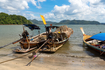 Fishing boats in the fishing village of Ban Ko Jum on the island of Ko Jum. A long-tail boat is loaded with fish and lobster traps. artisanal fishing is an important factor of local economy