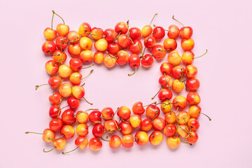 Frame made of sweet yellow cherries on lilac background