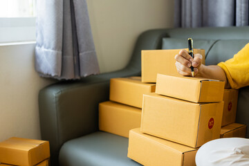  SME Startup, small business, female entrepreneur, working, unpacking, checking orders online To...