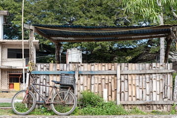 Fototapeta na wymiar rustic house with bicycle at the gate