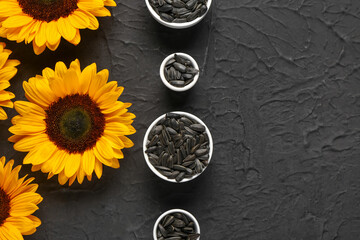 Sunflowers and bowls with seeds on black background