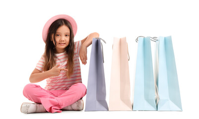 Cute little girl with shopping bags isolated on white