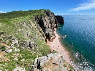 The beautiful Southeastern coast of the island of Shkota in August in sunny weather. Russia,...
