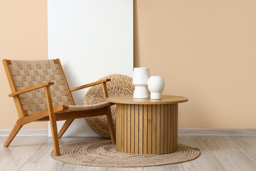 Fototapeta na wymiar Stylish wicker armchair and wooden coffee table near beige wall