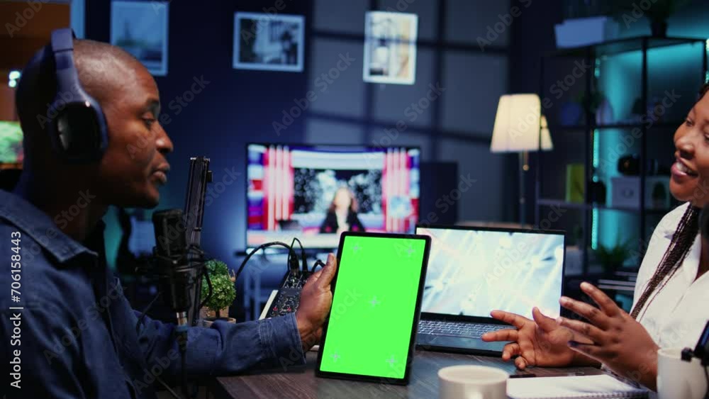 Poster Isolated screen tablet in front of show host recording podcast, enjoying nice conversation with happy guest. Chroma key device in professional studio used for podcasting live session with woman