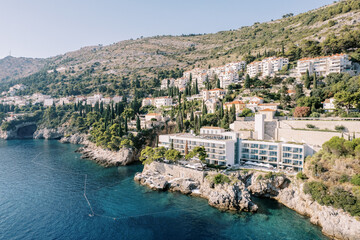 Expensive hotel Villa Dubrovnik on a mountainside with a multi-tiered stone beach by the sea....