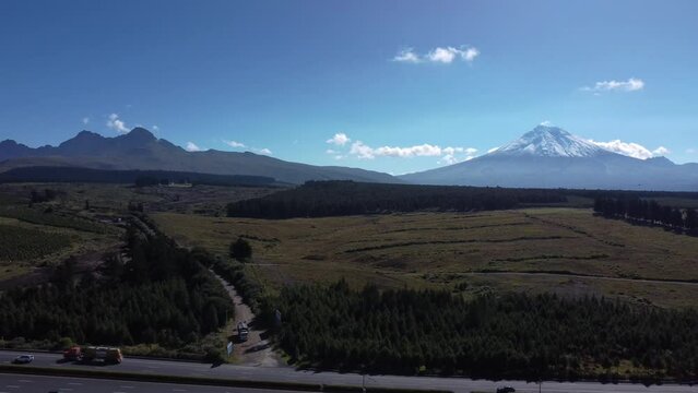 Snow capped volcanic peaks Cotopaxi Ruminahui from Ecuador highway E35 aerial