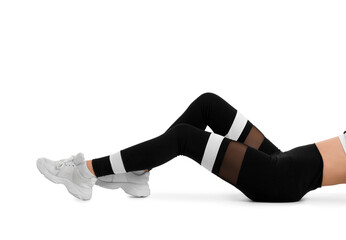 Sporty young woman in leggings lying on white background
