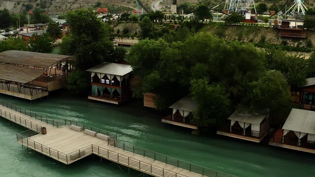 Gazebos for relaxation on the river bank. Aerial photography along the shore. Summer shots.