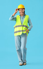 Female worker in reflective vest on blue background