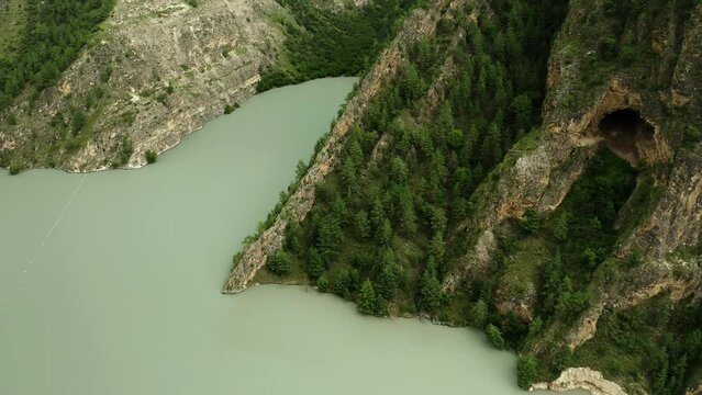 Mountain landscape with green trees and a small lake