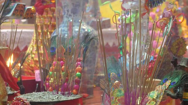 Bright colored Incense sticks in front of a colorful chinese temple