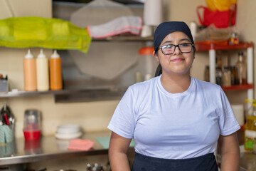 Portrait of a young latin female chef in a kitchen