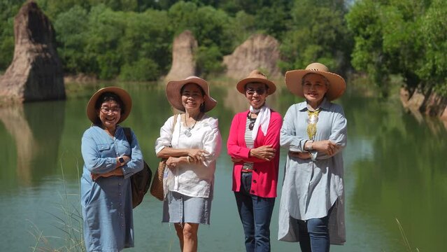 Group of Asian senior aging retirement women friends looking camera smile laugh taking pictures together with fun, adventure traveling to new experience, healthy elderly pensioner females relationship