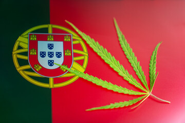 hemp leaf on background of the portuguese flag. Concept of legalization and changes in legislation...