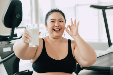 sport healthy fat women happy smiling enjoy drink milk and diet exercise activity in fitness sport club