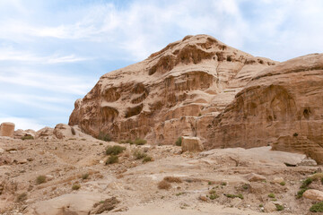Obraz premium Bizarre shapes of sandstone mountains at beginning of Nabatean Kingdom tourist route in the capital of the Nabatean Kingdom Petra in Wadi Musa city in Jordan
