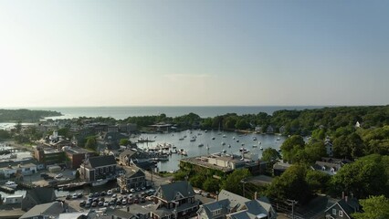 Rising drone shot of Cape Cod's protected "Eel Pond" harbor filled with boats.