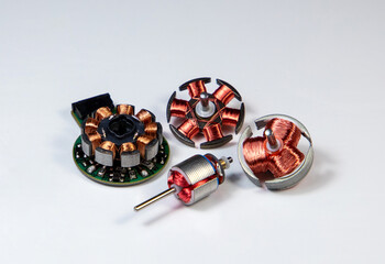 Copper wire coils from DC electric motors on white background