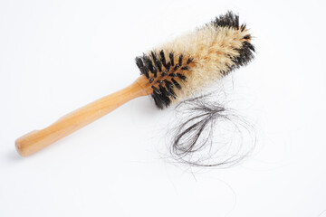 Hair loss fall with comb brush isolated on white background.