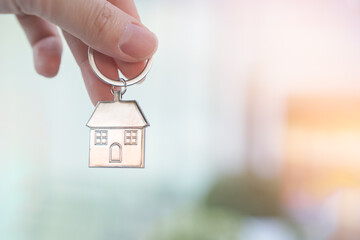 Hand holding house key. Decision to choose the best property with your right for a good start in life, Real estate financial and new housing loans concept. - obrazy, fototapety, plakaty